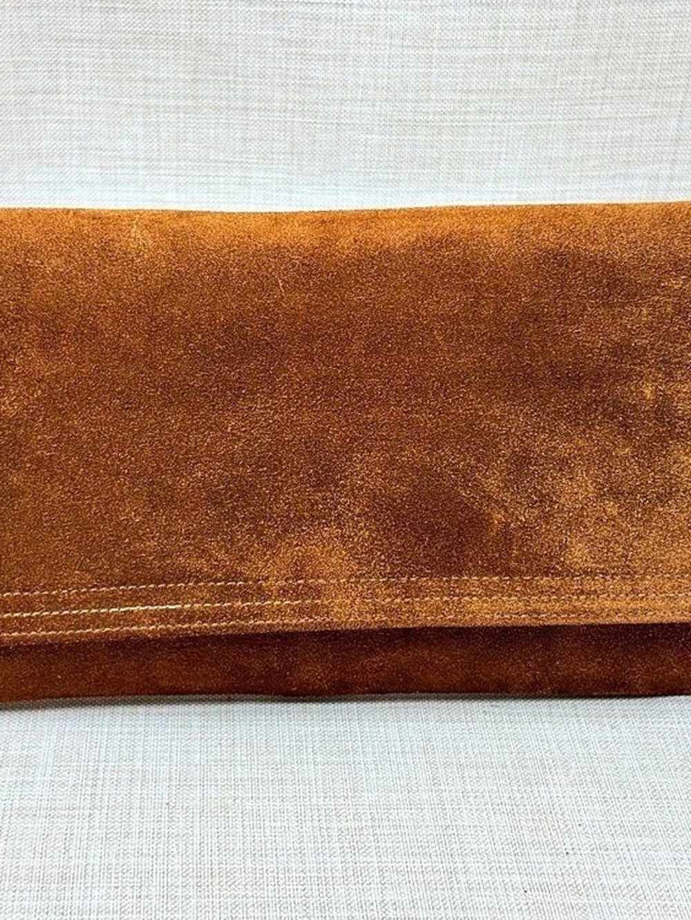Kham & Nate’s brown suede clutch